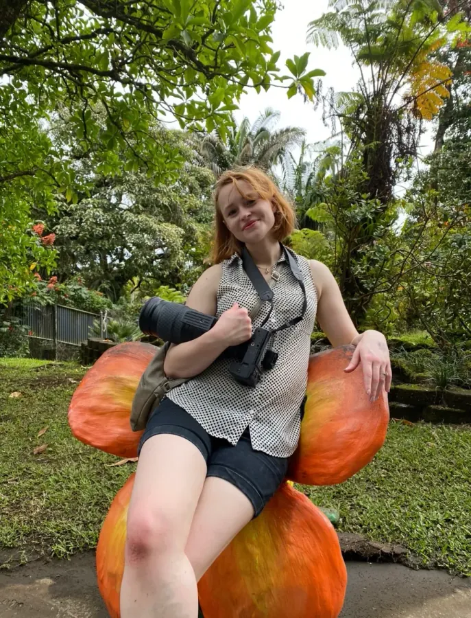 Hannah Burke relaxing in a tropical garden during a trip
