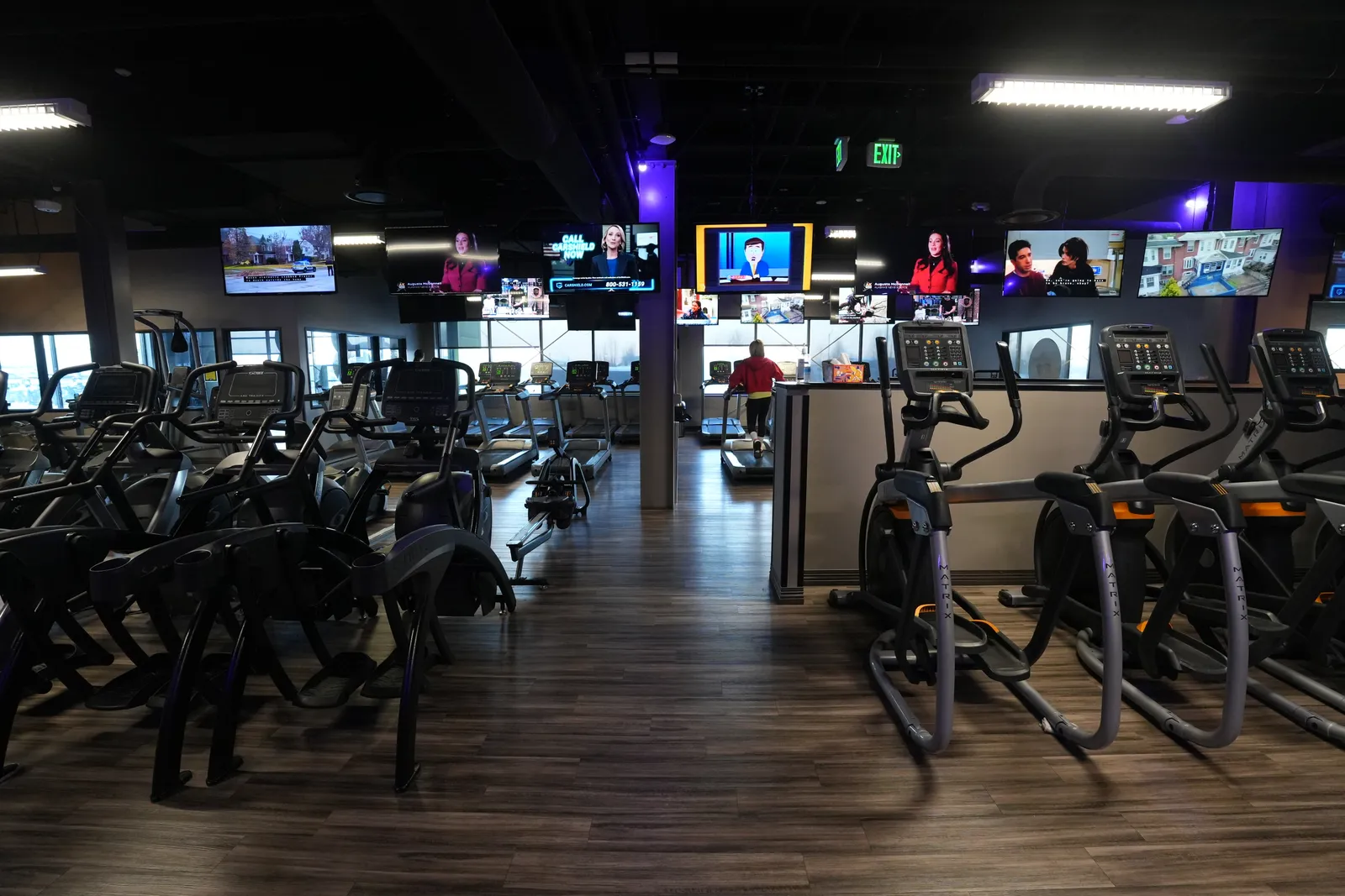 Cardio area with ellipticals, exercise bikes, and TV screens at Body Renew Alaska in South Anchorage