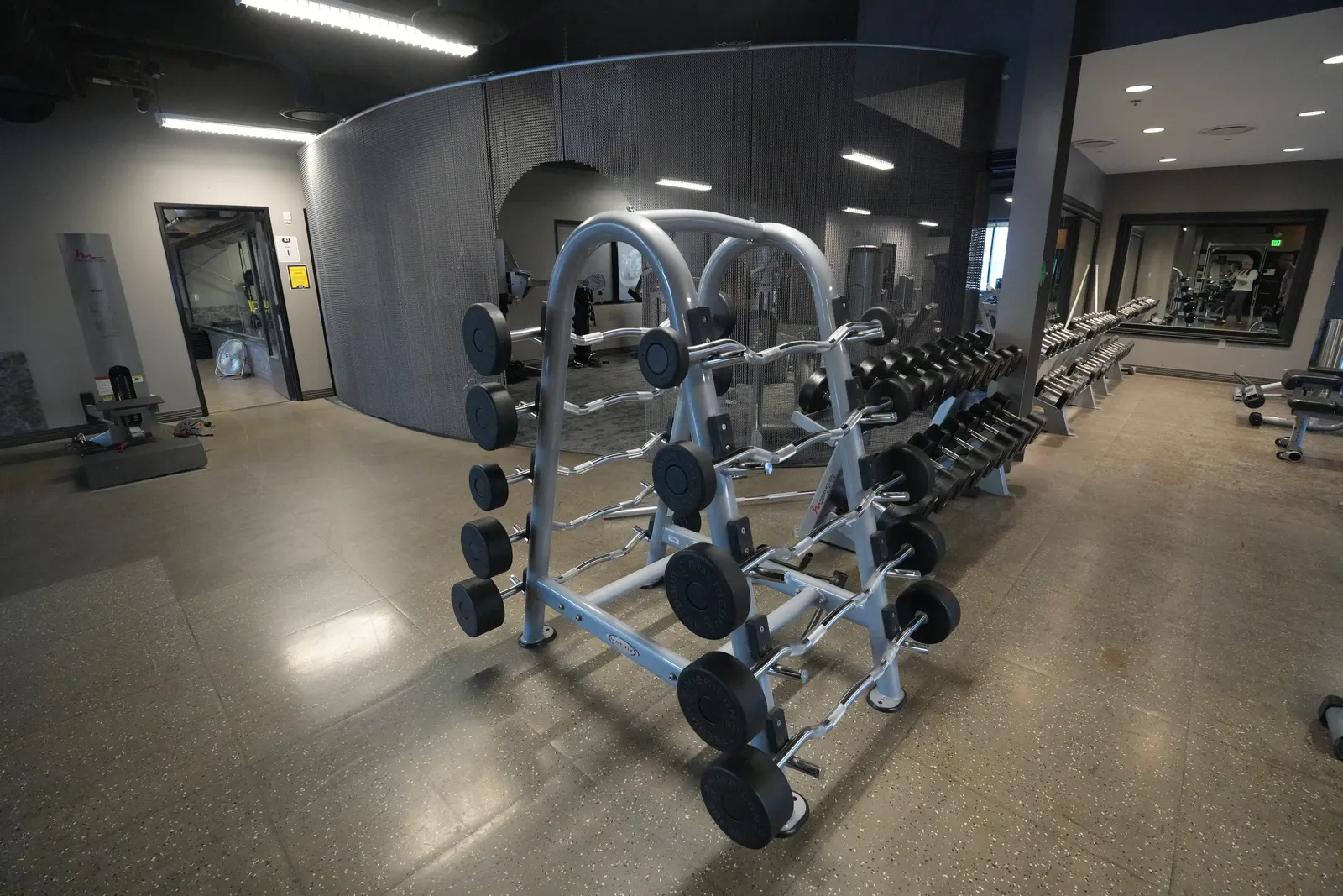 Rack of fixed barbells and curl bars at Body Renew Alaska in South Anchorage