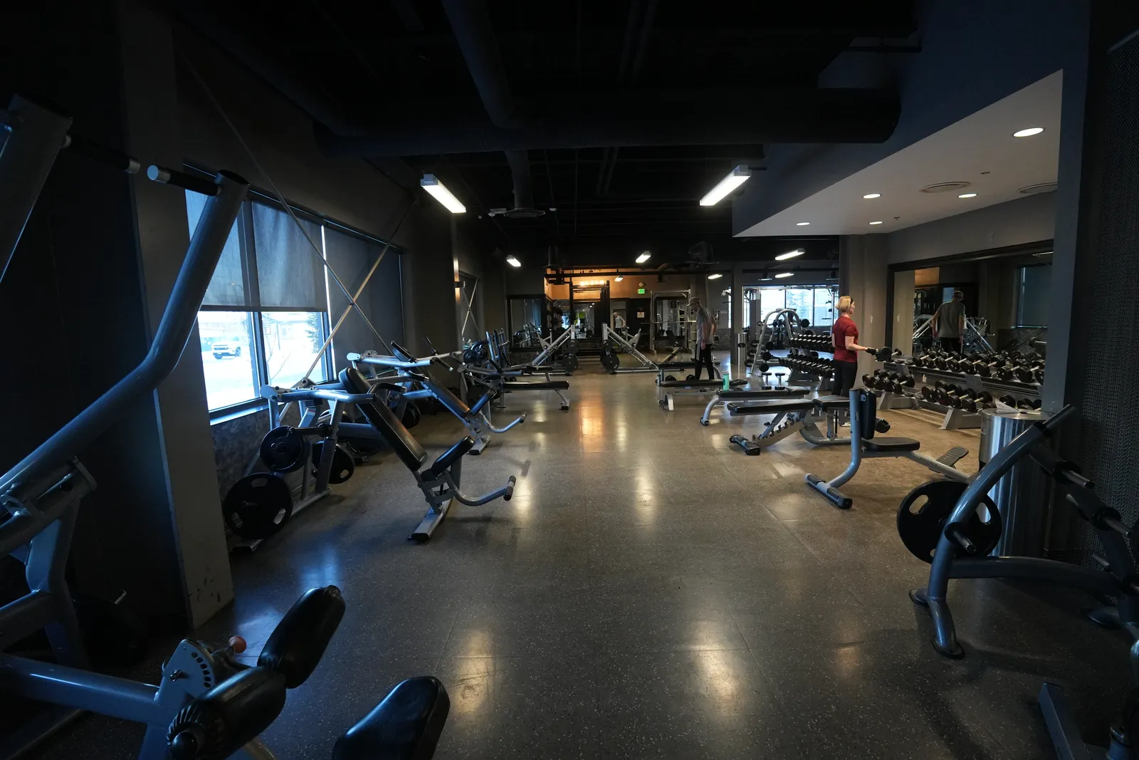 Strength training floor with benches, dumbbells, and large windows at Body Renew Alaska in South Anchorage